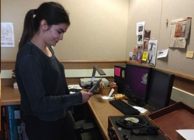 Student taking photos of record player