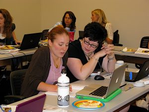 Erin Busch-Grabmeyer (right) consults with fellow teacher participant Rose Daum during the 2010 CRWP Summer Institute